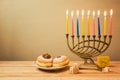 Jewish holiday Hanukkah celebration with menorah and sufganiyot