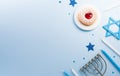 Jewish holiday Hanukkah concept. Top view of sweet donuts, menorah and candles on blue background Royalty Free Stock Photo