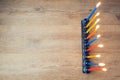 Jewish holiday Hanukkah creative background with menorah on wooden table. View from above. Retro filter effect.