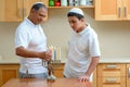 Jewish holiday Hanukkah. Jewish Dad and teenager son lighting Chanukkah Candles in a menorah for the holdiay Royalty Free Stock Photo