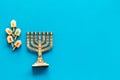 Jewish holiday Hanukkah with menorah - traditional Candelabra - and wooden dreidels spinning top. Blue background, top Royalty Free Stock Photo