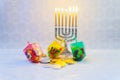 jewish holiday Hanukkah with menorah, wooden dreidels
