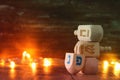 jewish holiday Hanukkah with wooden dreidels colection & x28;spinning top& x29; and gold garland lights on the table Royalty Free Stock Photo