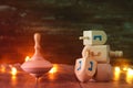 jewish holiday Hanukkah with wooden dreidels colection & x28;spinning top& x29; and gold garland lights on the table Royalty Free Stock Photo