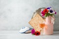 Jewish holiday Passover background with flowers, wine, matzo and seder plate