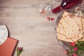 Jewish holiday Passover background with matzah, seder plate and wine. View from above