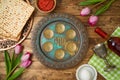 Jewish holiday Passover background with matzo, seder plate, wine and tulip flowers on wooden table Royalty Free Stock Photo