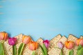 Jewish holiday Passover celebration concept with matzah and tulip flowers on wooden table. Pesah background