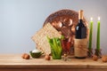 Jewish holiday Passover celebration concept with wine, matzah and seder plate on wooden table over gray background. Traditional Royalty Free Stock Photo