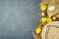 Jewish holiday Passover concept with matzah, seder plate and golden decorations on dark background Royalty Free Stock Photo