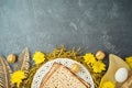 Jewish holiday Passover concept with matzah, seder plate and golden decorations on dark background Royalty Free Stock Photo