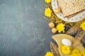 Jewish holiday Passover concept with matzah, seder plate and golden decorations on dark background Royalty Free Stock Photo