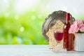 Jewish holiday Passover concept with wine, matzah, flowers and seder plate on wooden table over green bokeh background Royalty Free Stock Photo