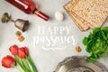 Jewish holiday Passover Pesah greeting card with seder plate, matzoh and red wine bottle.