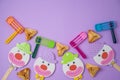 Jewish holiday Purim background with carnival mask, paper clown and hamantaschen cookies Royalty Free Stock Photo