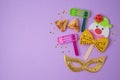 Jewish holiday Purim background with cute paper clowns character, hamantaschen cookies and carnival mask