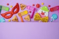 Jewish holiday Purim background with cute paper clowns character, hamantaschen cookies and carnival mask