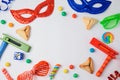 Jewish holiday Purim concept with hamantaschen cookies, carnival mask and noisemaker on white background.