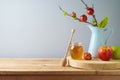 Jewish holiday r Rosh Hashanah concept. Honey jar and apples in wooden box on table background Royalty Free Stock Photo