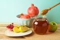 Jewish holiday Rosh Hashana background with honey, apple and pomegranate on wooden table Royalty Free Stock Photo