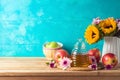 Jewish holiday Rosh Hashana background with honey jar, apple and sunflowers on wooden table Royalty Free Stock Photo