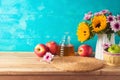 Jewish holiday Rosh Hashana background with honey jar, apples and sunflowers on wooden table. Kitchen counter with copy space for Royalty Free Stock Photo