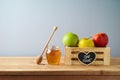 Jewish holiday Rosh Hashana background with honey jar and apples on wooden table Royalty Free Stock Photo
