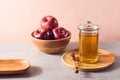 Jewish holiday Rosh Hashana background with honey and red apples. Modern still life composition