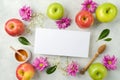 Jewish holiday Rosh Hashanah greeting card mock up. Top view background with apples, flowers and honey. Flat lay Royalty Free Stock Photo