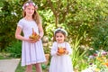 Jewish Holiday Shavuot.Harvest.Two little girls in white dress holds a basket with fresh fruit in a summer garden.