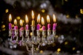 Jewish holiday symbol for Hanukkah in Hanukkiah Menorah burned candles on lit blurred bokeh