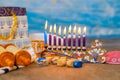 Jewish holiday symbol for Hanukkah is Hanukkiah Menorah with a flame burning