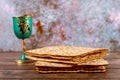 Jewish holiday table for Passover with matzah and cup of kosher wine