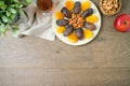 Jewish holiday Tu Bishvat concept with dried dates, fruits and nuts on wooden background. Flat lay, top view Royalty Free Stock Photo