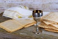 Jewish holidays: Passover Pesach matzah and a silver cup full of wine with a traditional blessing