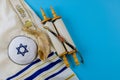 Jewish holidays, during prayer items kippa with prayer shawl tallit on shofar, torah scroll Royalty Free Stock Photo