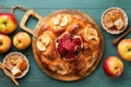 Jewish Holidays - Rosh Hashanah or Rosh Hashana. Pomegranate, apples, honey and round challah on old wooden blue table background