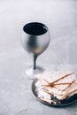 Jewish kiddush wine cup for passover with matzot, matzo bread. Pesah holiday. Banner with copy space. Christian communion concept