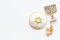 Jewish Kippah Yarmulkes hats with menorah on white table. Top view, copy space