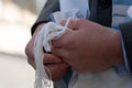 Holding tzitzit around the hand during Jewish prayer