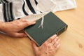 Jewish man hands holding a Prayer book, praying, next to tallit. Jewish traditional symbols. Rosh hashanah jewish New Year holida