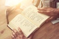 Jewish man hands holding a Prayer book, praying, next to tallit. Jewish traditional symbols. Rosh hashanah jewish New Year holida Royalty Free Stock Photo