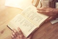 Jewish man hands holding a Prayer book, praying, next to tallit. Jewish traditional symbols. Rosh hashanah jewish New Year holida Royalty Free Stock Photo