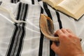 Jewish man hands next to Prayer book, praying, next to tallit. Jewish traditional symbols. Rosh hashanah jewish New Year holiday Royalty Free Stock Photo