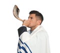 Jewish man with kippah and tallit blowing shofar. Rosh Hashanah celebration