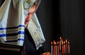 A man lighting candles in a menorah Jewish man in prayer Royalty Free Stock Photo