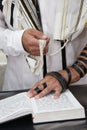 An jewish man is reading his bible and praying