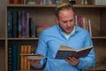 Jewish man reads from the Haggadah as they celebrate Passover.