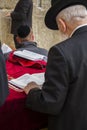 Jewish man standing, leaning and reading in a bible book, during Royalty Free Stock Photo