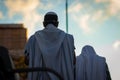 A Jewish man wrapped in a tallit prays outside the synagogue on Sukkot